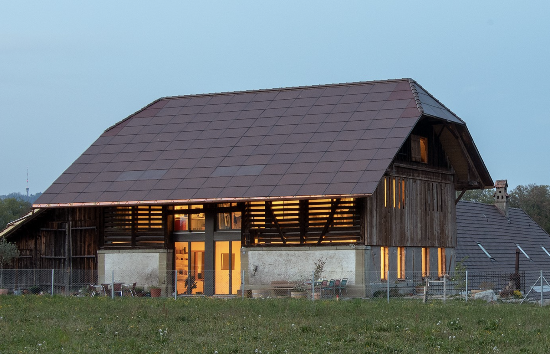 Old farmhouse with solar panels on the roof (Switzerland)