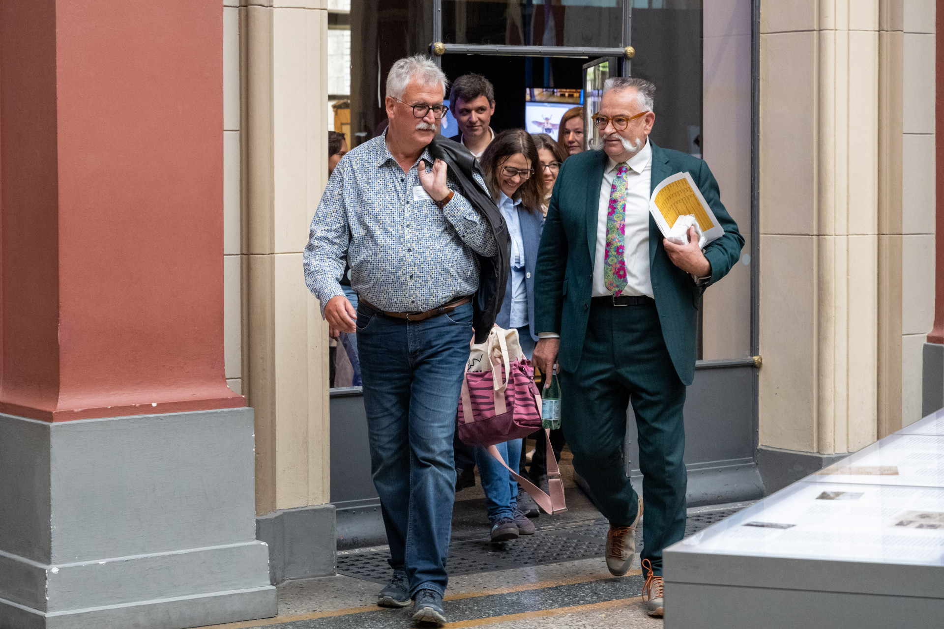 Eine Gruppe verlässt ein Gebäude, vorn in der Reihe gehen Johannes Vogel und Josef Settele.