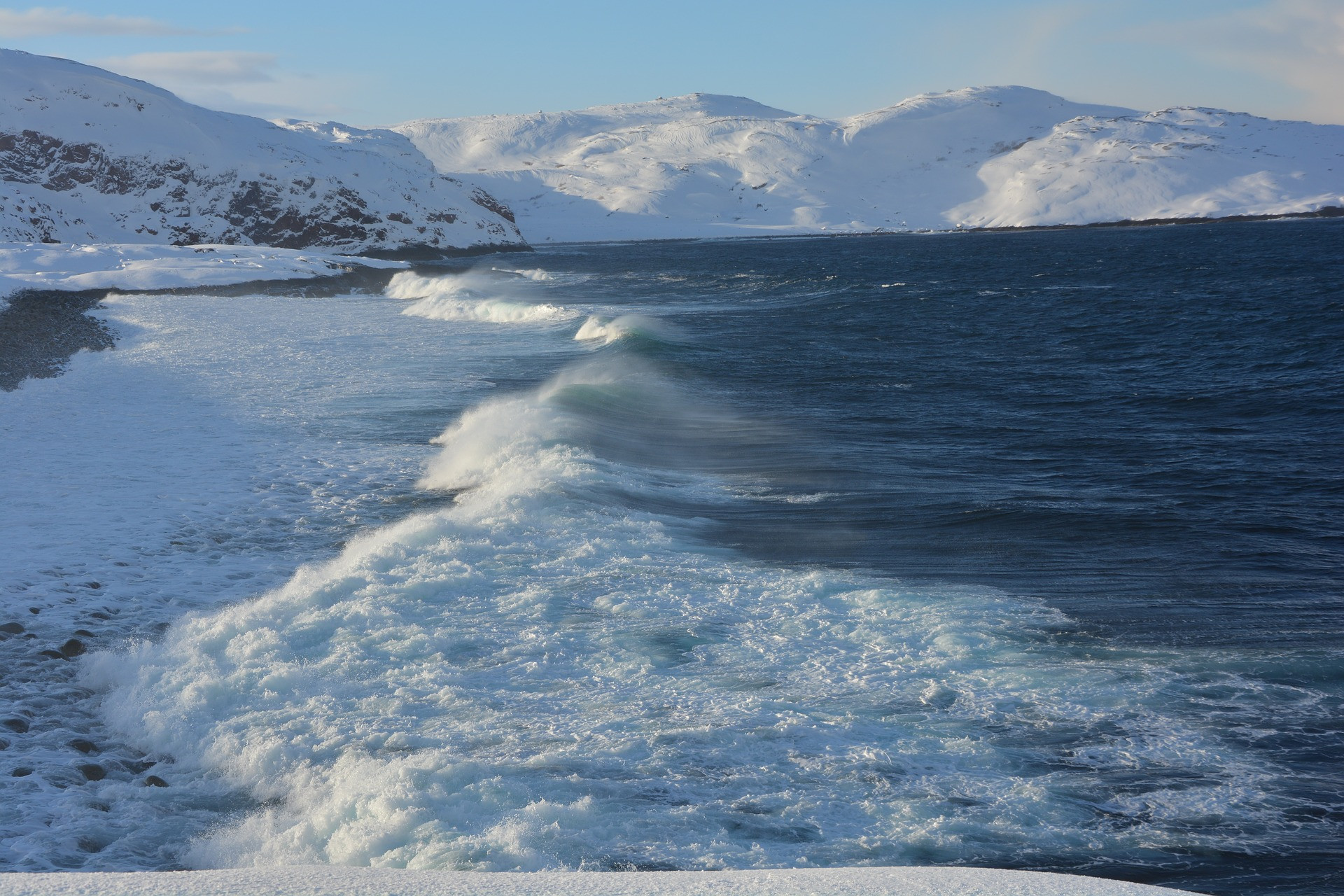 A coastline with ocean and snow-capped mountains