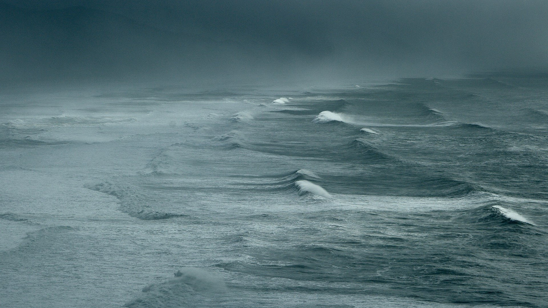 A stormy sea under a grey sky